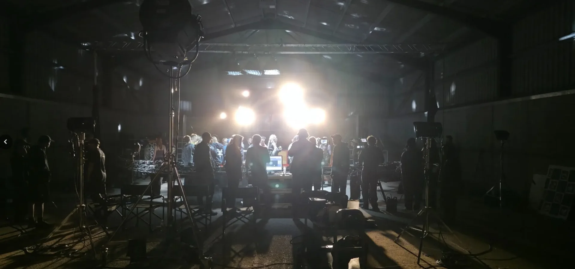 The barn set lit for the party scene, with the Argus rig arc in the foreground and the crowd on set