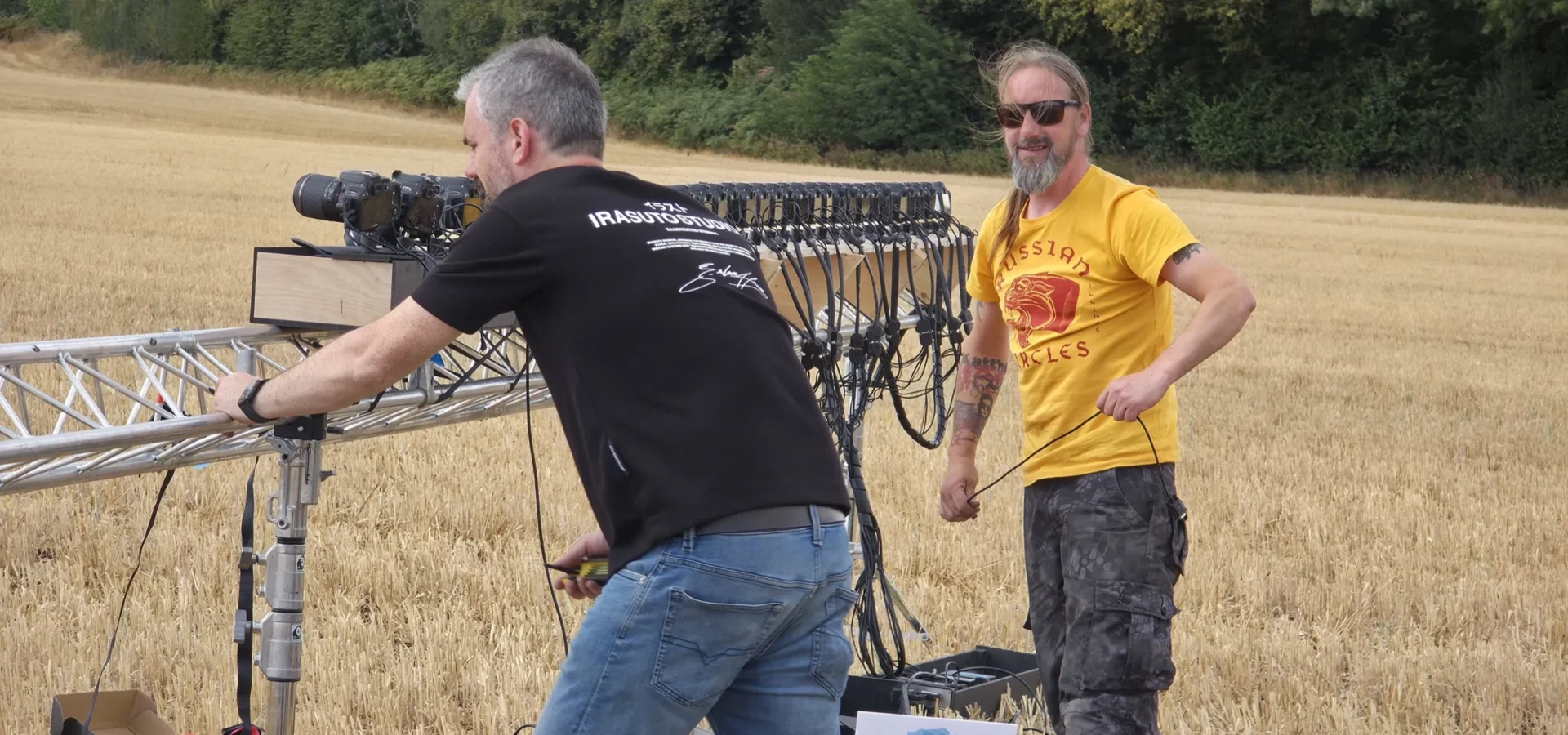 Ian and Tom lifting the line truss into position in the field