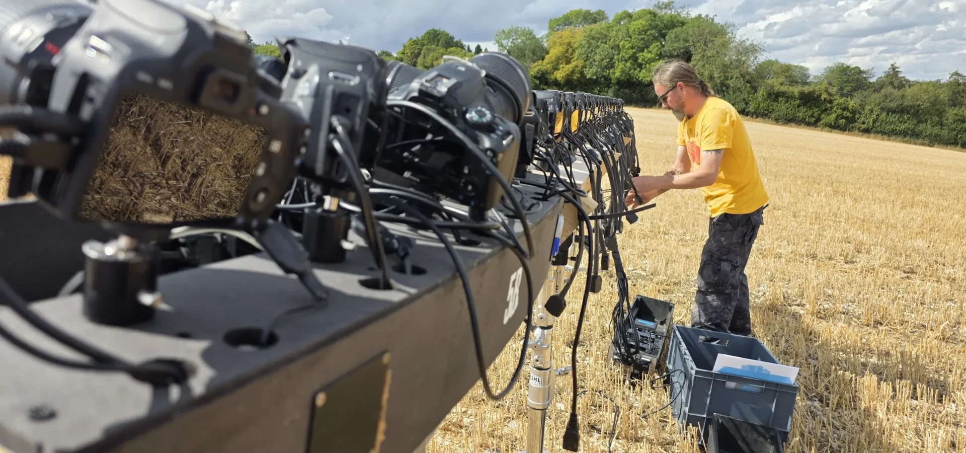 Tom cabling the stills cameras along the line truss in the field